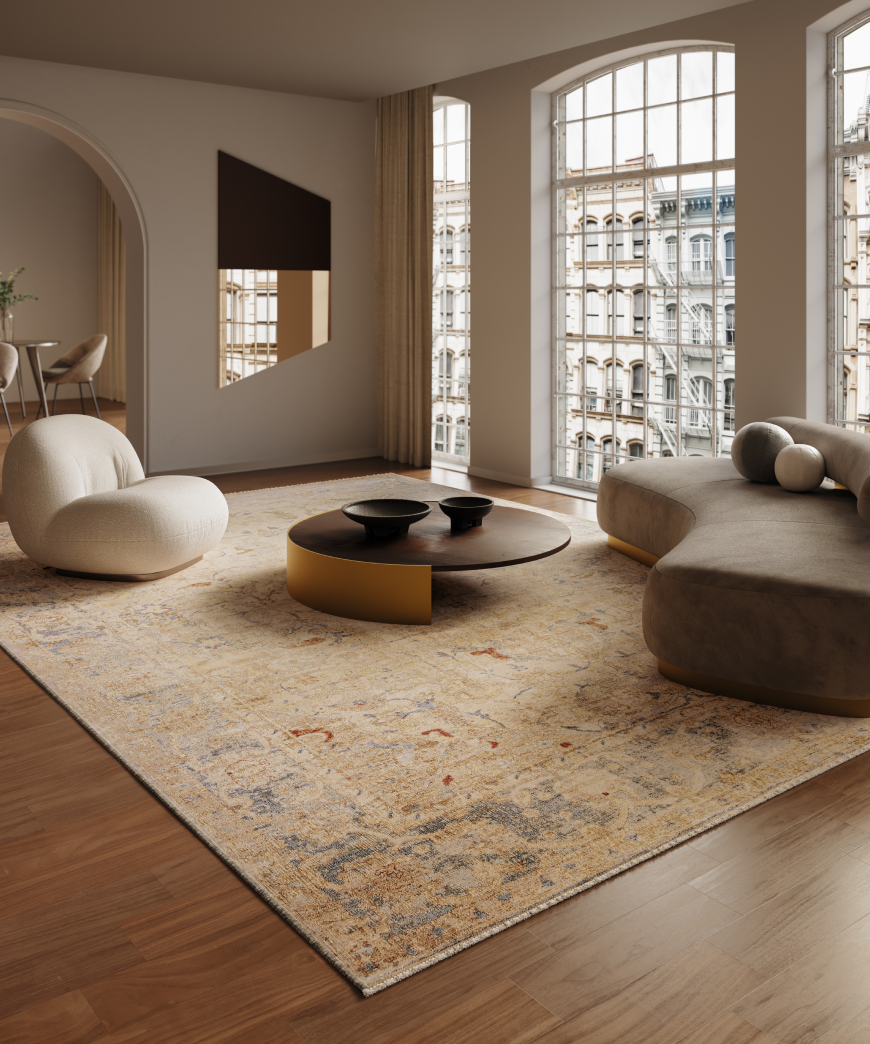 Modern living room with large designer carpet on a wooden floor with a couch, puffy chair and a coffee table.