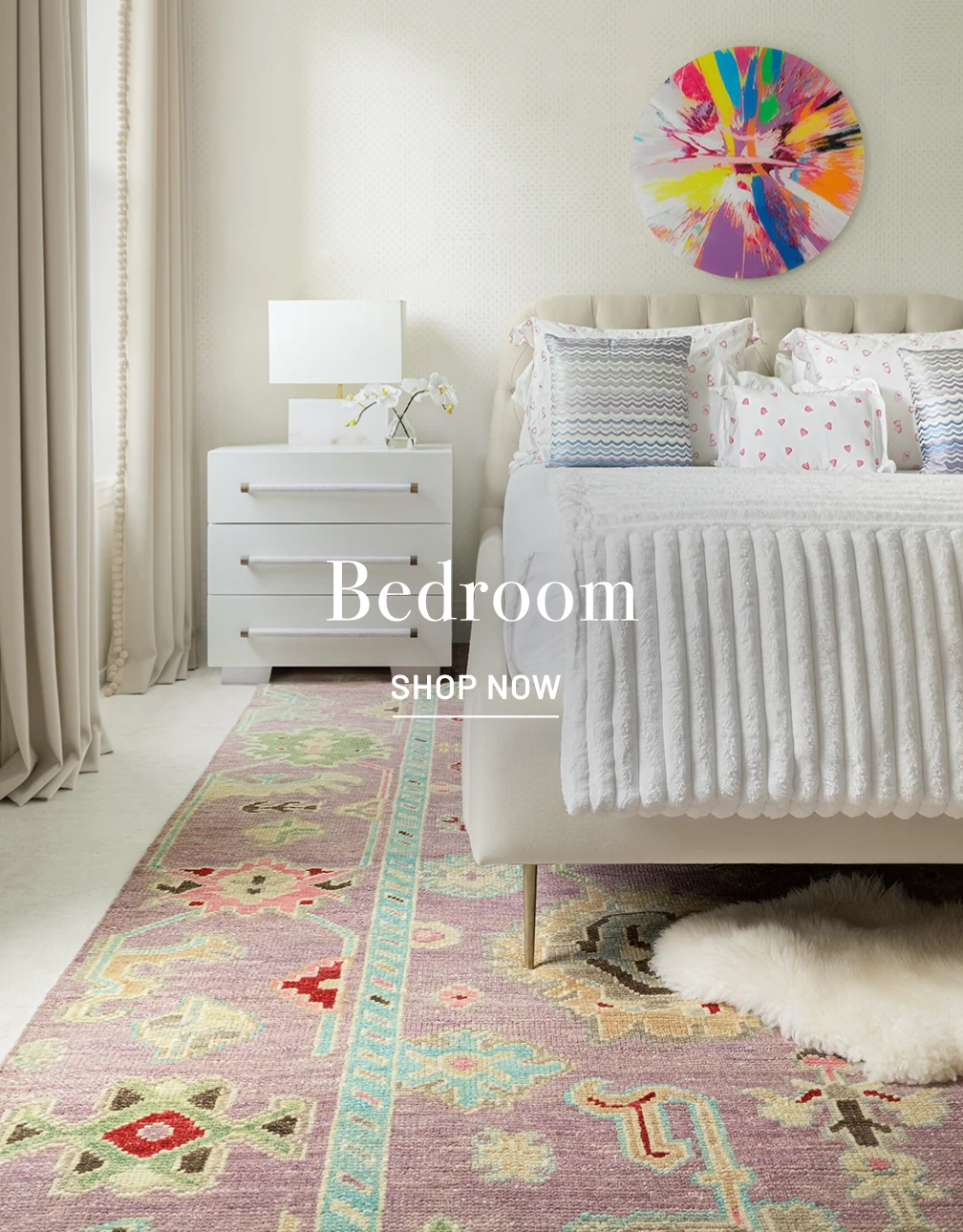 Bedroom with Stark multi-colored rug and white bedding. Bedroom text in white with Shop Now below it in white.