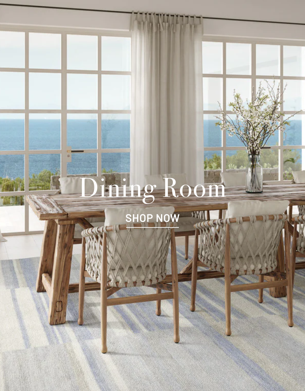 Ocean view dining room scene with Stark rug and wooder table with chairs. Dining Room in white text overlay with Shop Now below it.